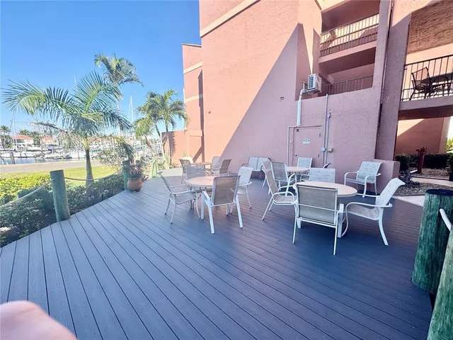 a view of a roof deck with table and chairs with wooden floor