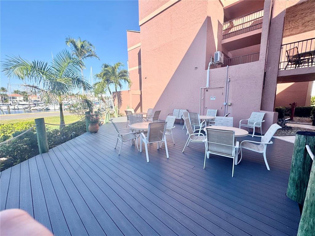 3170 Matecumbe Key Road, Unit 115 Punta Gorda, FL 33955 - Photo 26 of 43 a view of a roof deck with table and chairs with wooden floor