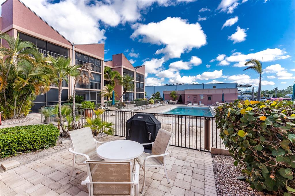 3170 Matecumbe Key Road, Unit 115 Punta Gorda, FL 33955 - Photo 27 of 59 a view of a chairs and table in a patio