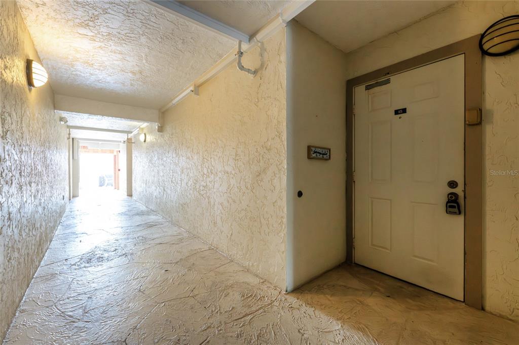 3170 Matecumbe Key Road, Unit 115 Punta Gorda, FL 33955 - Photo 29 of 59 a view of a hallway with wooden shelves