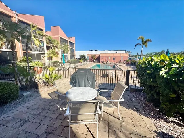 a view of a chairs and table in patio