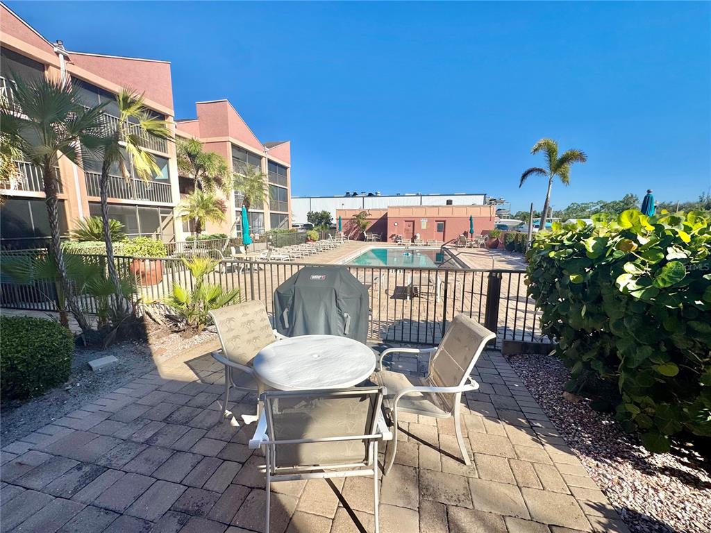 3170 Matecumbe Key Road, Unit 115 Punta Gorda, FL 33955 - Photo 32 of 43 a view of a chairs and table in patio