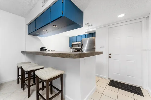 a kitchen with stainless steel appliances a sink cabinets and wooden floor