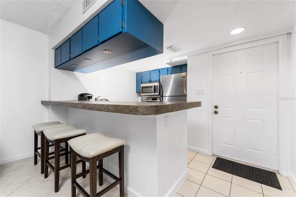3170 Matecumbe Key Road, Unit 115 Punta Gorda, FL 33955 - Photo 4 of 59 a kitchen with stainless steel appliances a sink cabinets and wooden floor