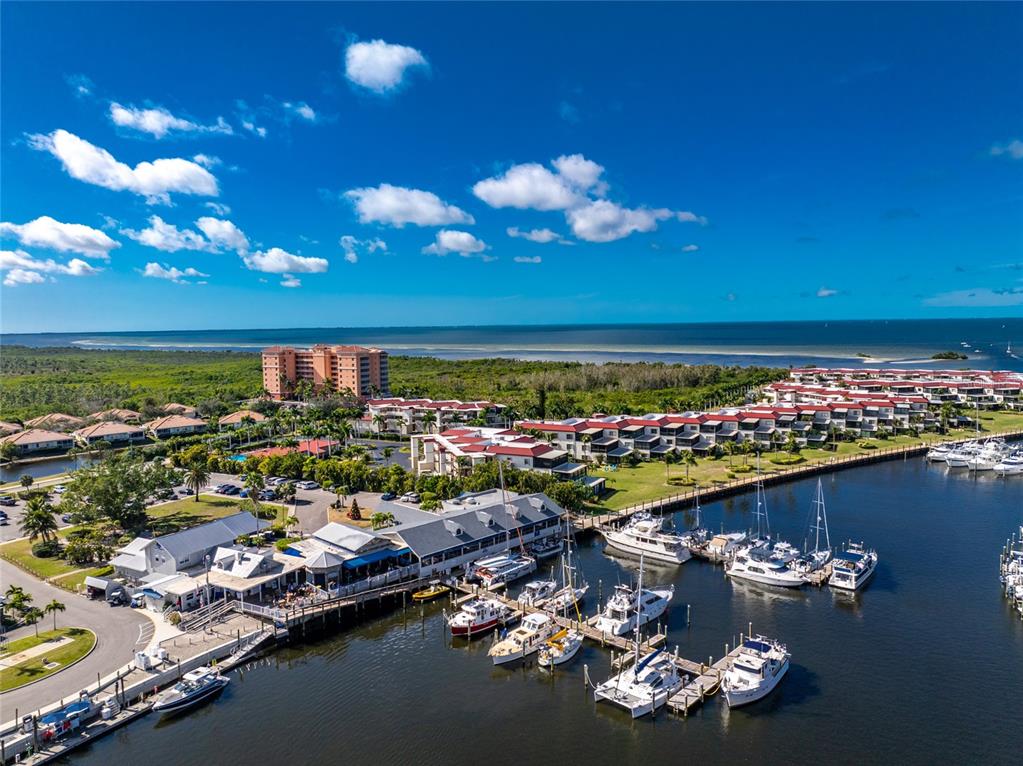 3170 Matecumbe Key Road, Unit 115 Punta Gorda, FL 33955 - Photo 49 of 59 a view of a lake with a dining table and chairs with wooden floor