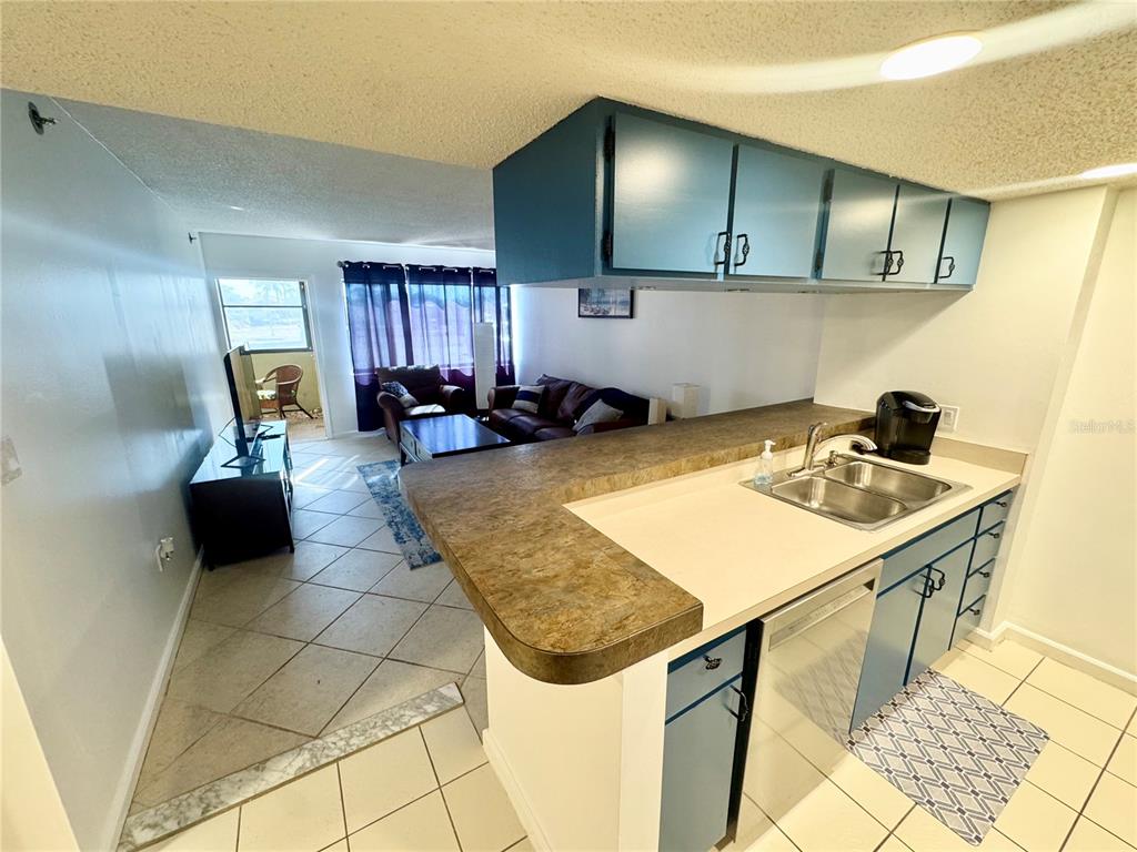 3170 Matecumbe Key Road, Unit 115 Punta Gorda, FL 33955 - Photo 6 of 43 a kitchen with a sink and a stove top oven