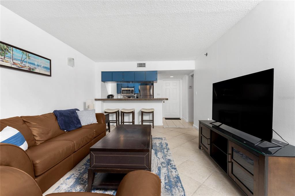 3170 Matecumbe Key Road, Unit 115 Punta Gorda, FL 33955 - Photo 6 of 59 a living room with furniture and a flat screen tv
