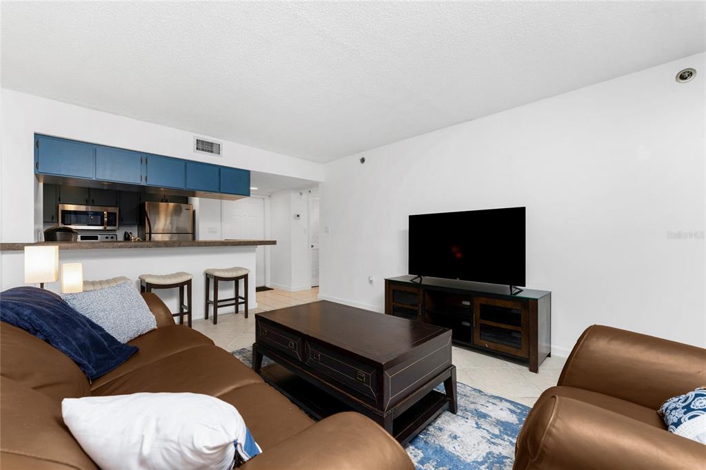 3170 Matecumbe Key Road, Unit 115 Punta Gorda, FL 33955 - Photo 7 of 59 a living room with furniture and a flat screen tv