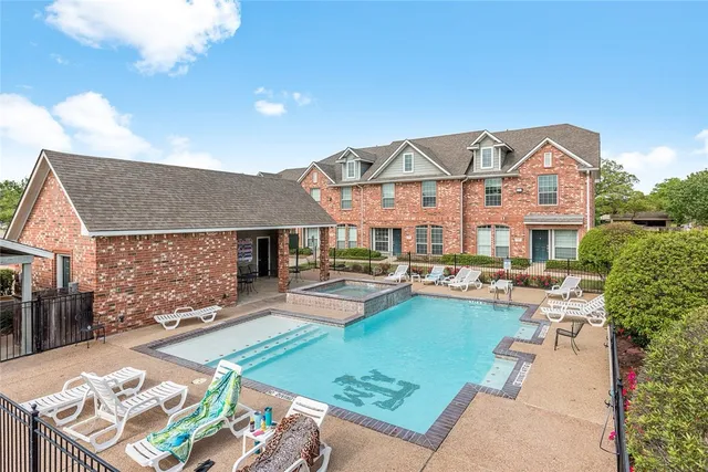 a view of a wooden house with a small yard and wooden fence