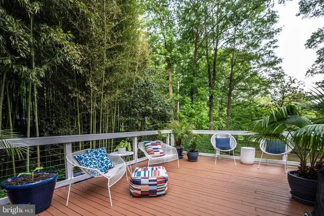 a view of roof deck with wooden floor and outdoor seating