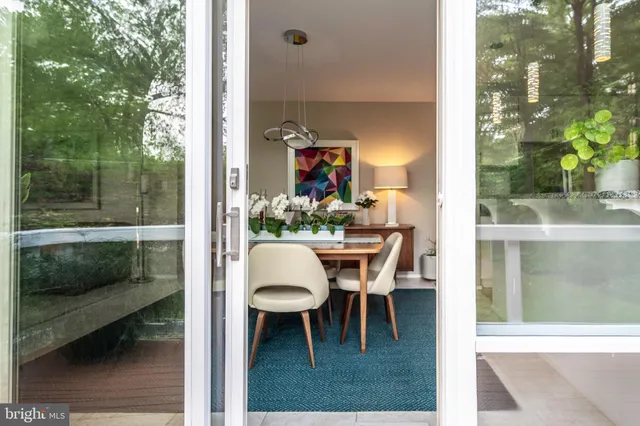 a view of a dining room with a table and chairs