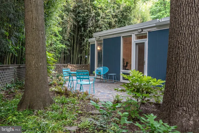 a view of a chair and table in backyard of the house
