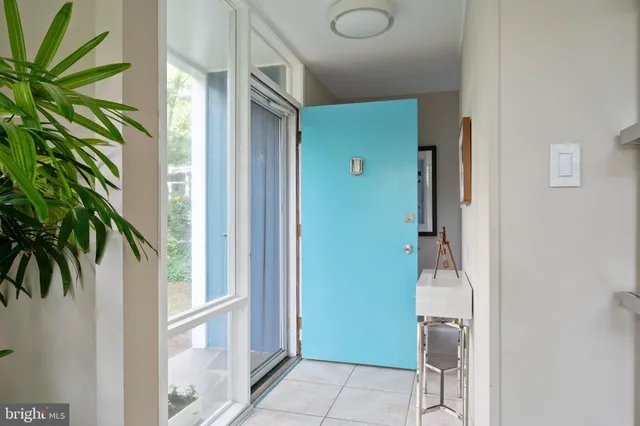 a view of a hallway with entryway and front door