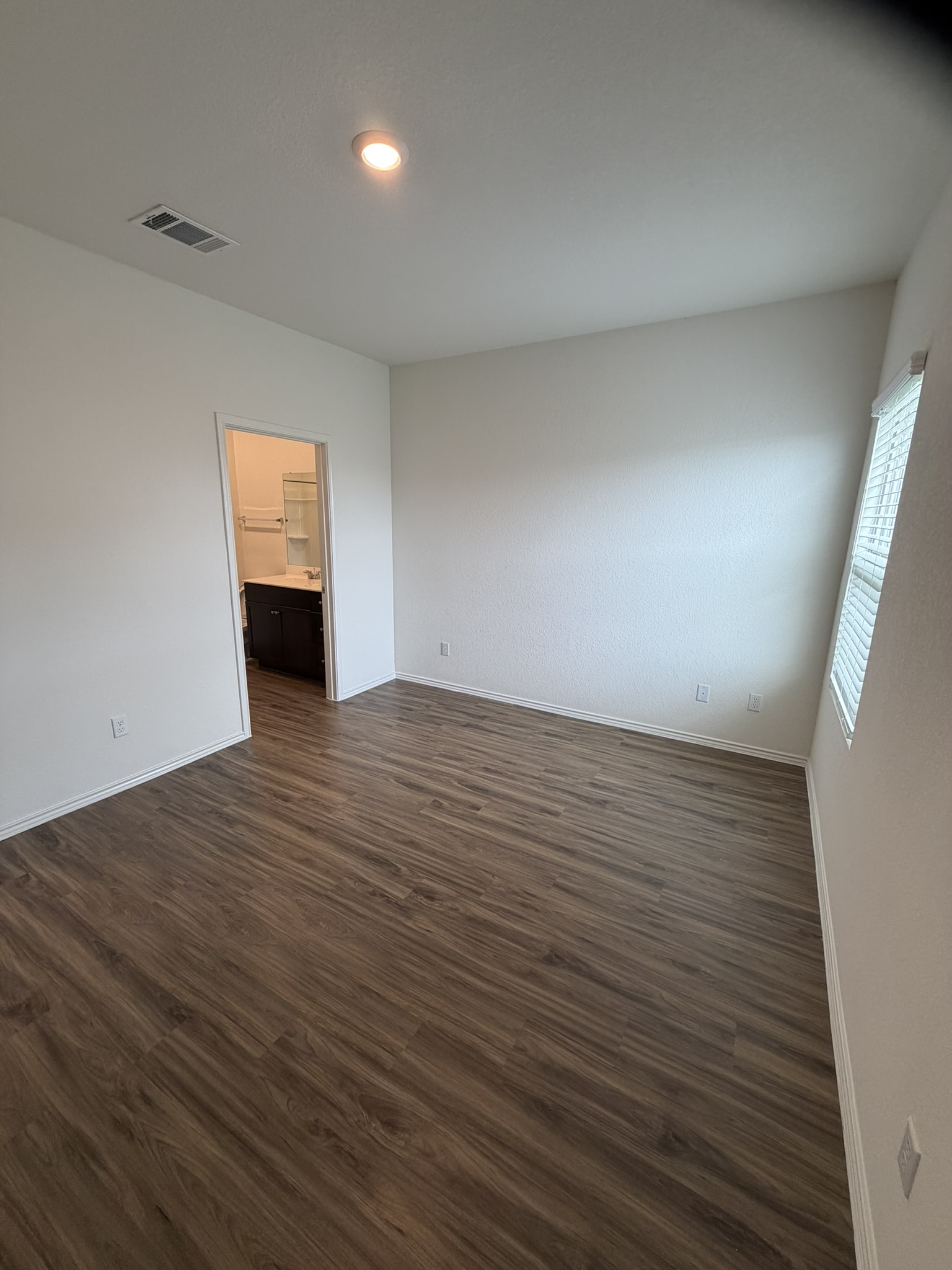 408 Buckners Street Georgetown, TX 78626 - Photo 10 of 15 wooden floor in an empty room with a window