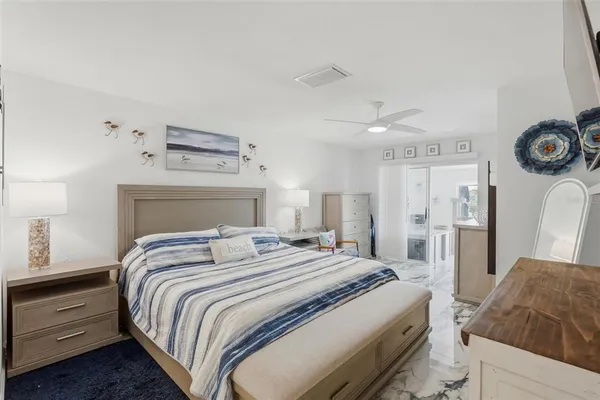 a bedroom with a bed and a dresser in it