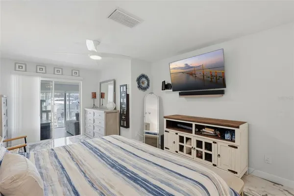 a bedroom with furniture and flat screen tv