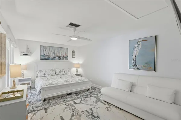 a living room with furniture and painting on the wall