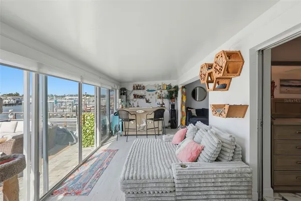 a bedroom with furniture and a floor to ceiling window