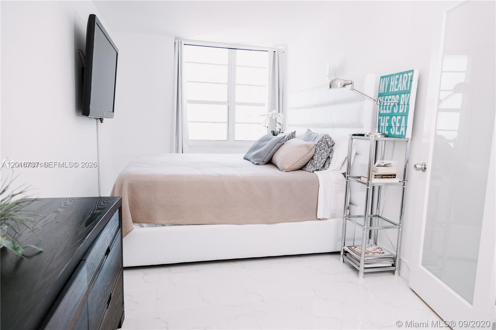 100 Lincoln Road, Unit 1526 Miami Beach, FL 33139 - Photo 8 of 9 a bedroom with a bed and flat screen tv