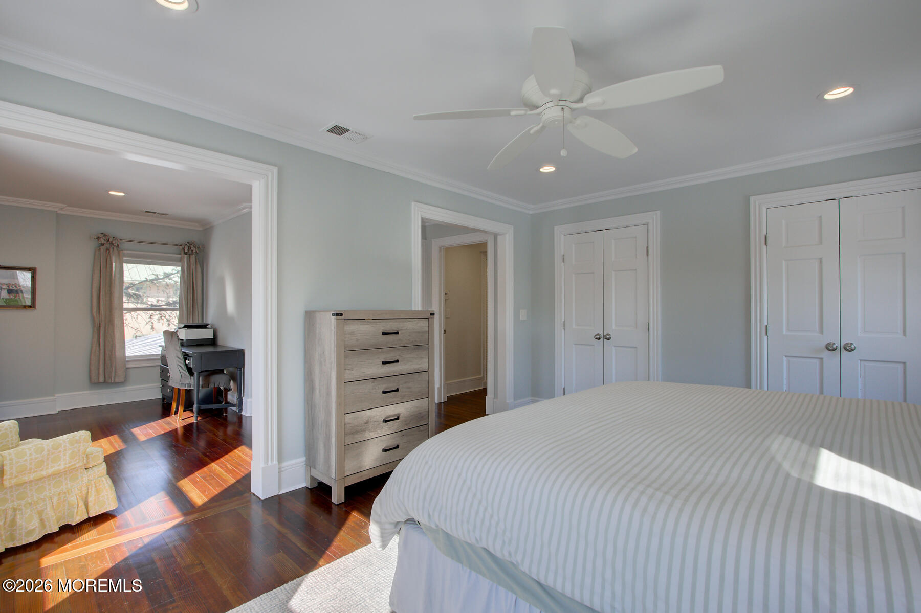39 River Road Rumson, NJ 07760 - Photo 16 of 36 a spacious bedroom with a bed and a chandelier