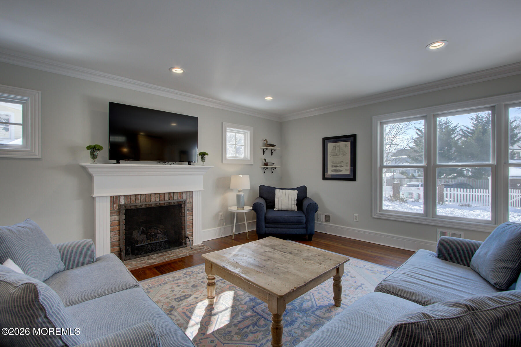 39 River Road Rumson, NJ 07760 - Photo 4 of 36 a living room with furniture a flat screen tv and a fireplace