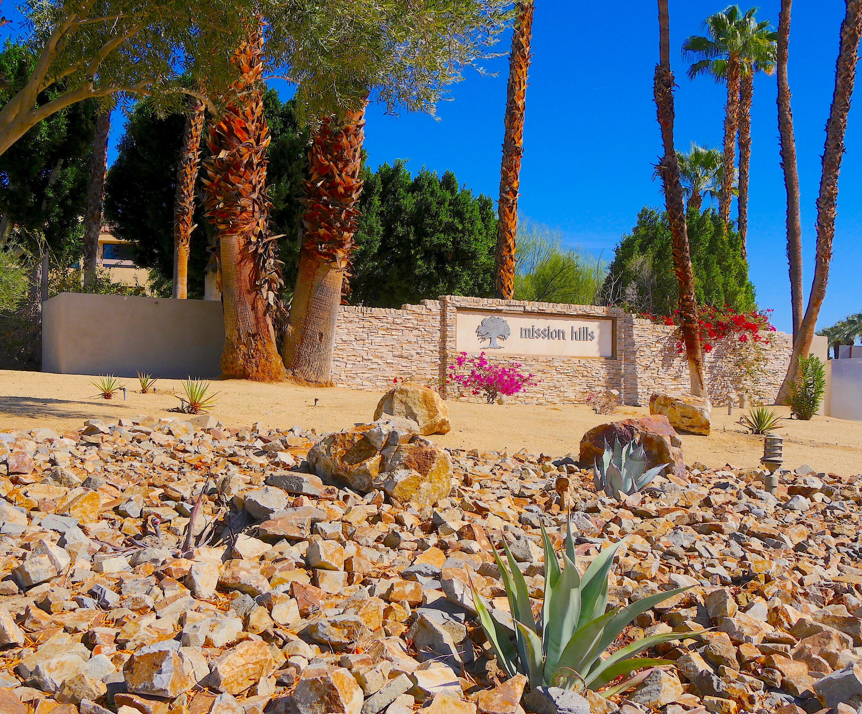 14 Mission Court Rancho Mirage, CA 92270 - Photo 2 of 17 a view of a white house with a yard