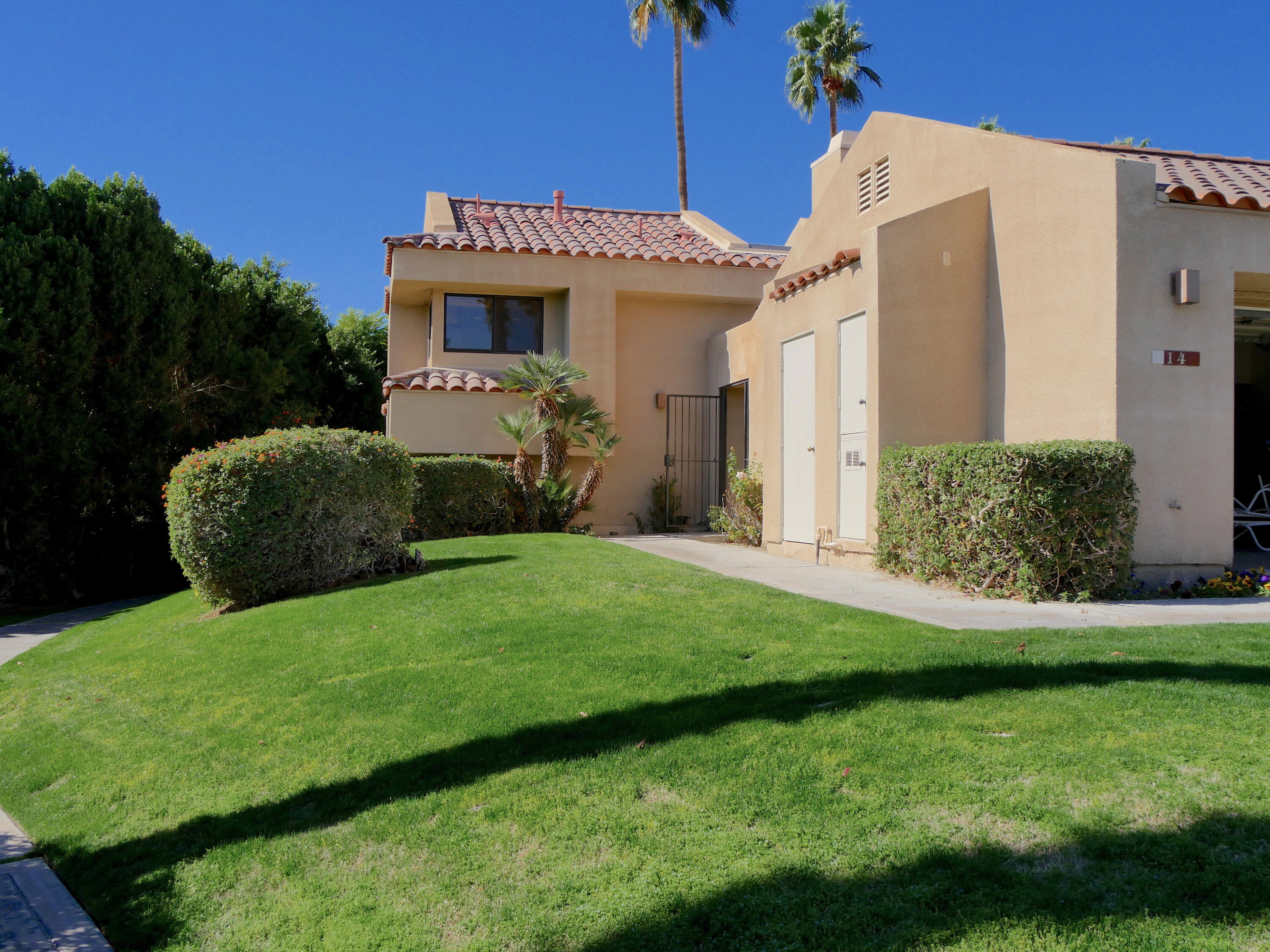 14 Mission Court Rancho Mirage, CA 92270 - Photo 4 of 17 a front view of a house with a yard