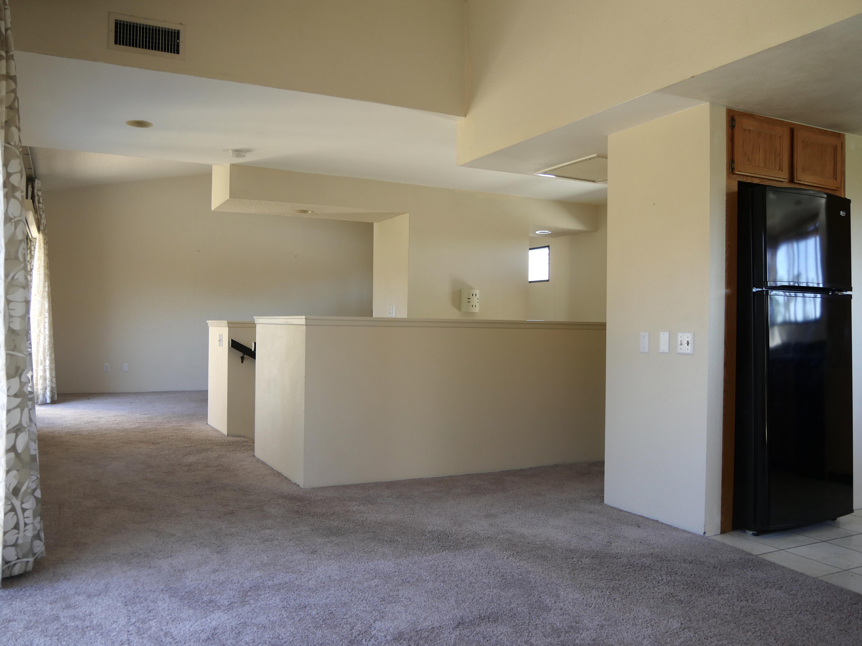 14 Mission Court Rancho Mirage, CA 92270 - Photo 5 of 17 a view of a hallway with wooden cabinets