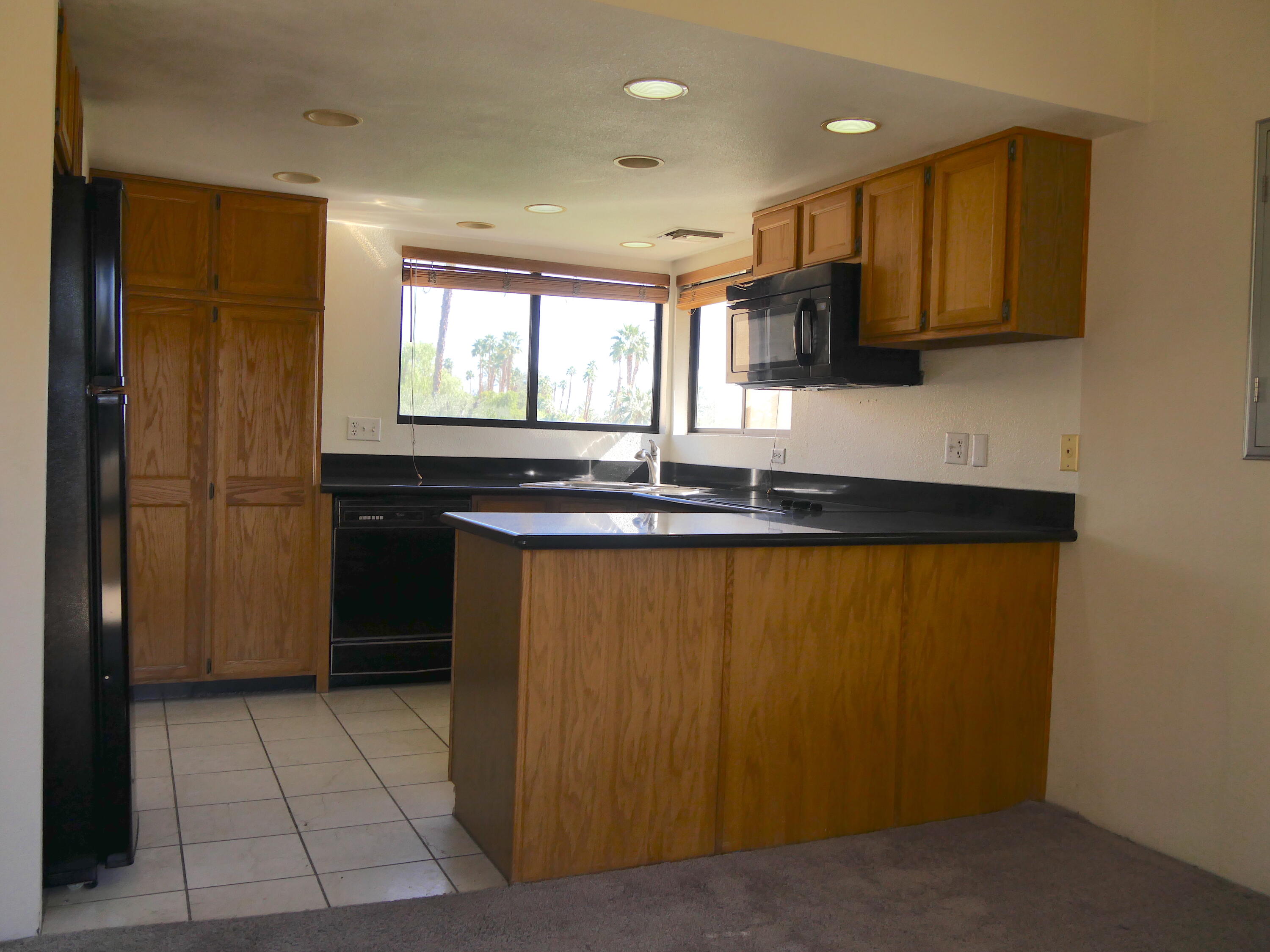 14 Mission Court Rancho Mirage, CA 92270 - Photo 7 of 17 a kitchen with stainless steel appliances granite countertop a refrigerator and a sink
