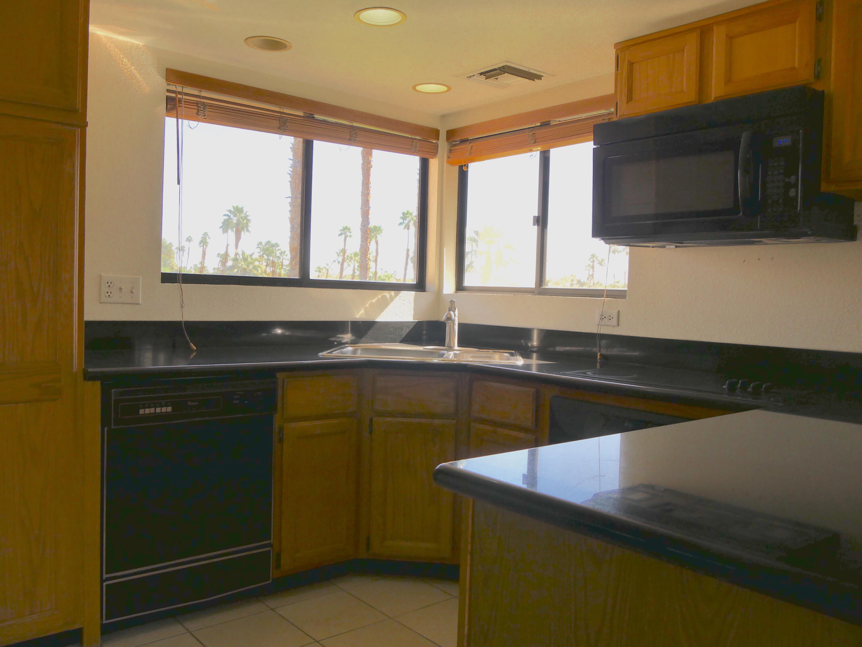 14 Mission Court Rancho Mirage, CA 92270 - Photo 8 of 17 a kitchen with a sink and a window