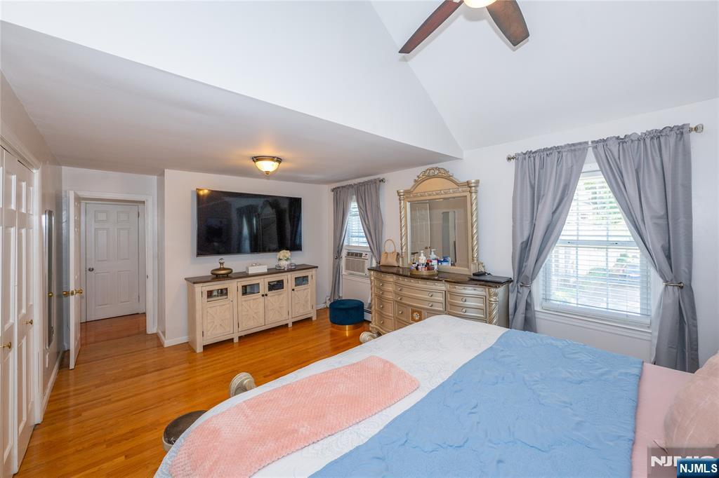 690 Garden Street Maywood, NJ 07607 - Photo 31 of 49 a large bedroom with a bed and a flat screen tv