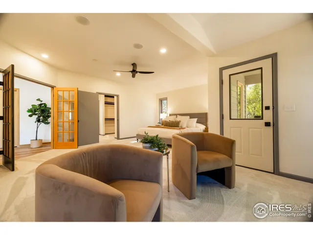 a living room with furniture a potted plant and a fireplace