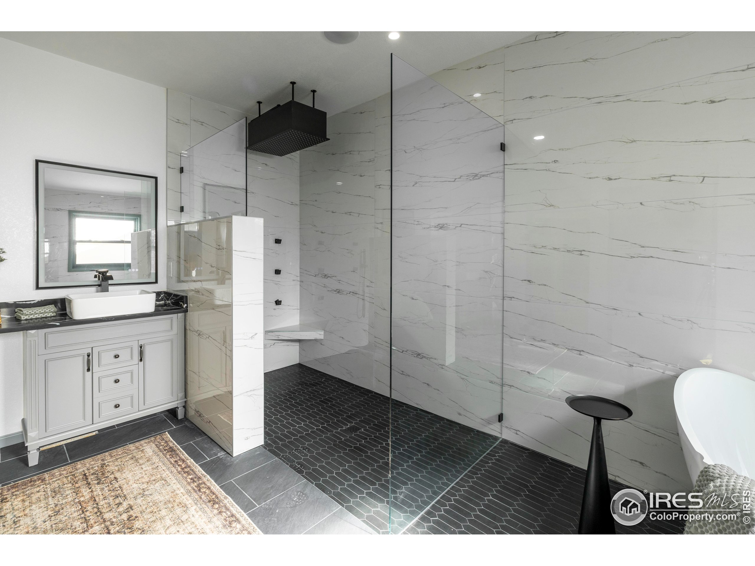 6465 Hidden Springs Road Fort Collins, CO 80526 - Photo 25 of 50 a bathroom with a sink a toilet and large mirror