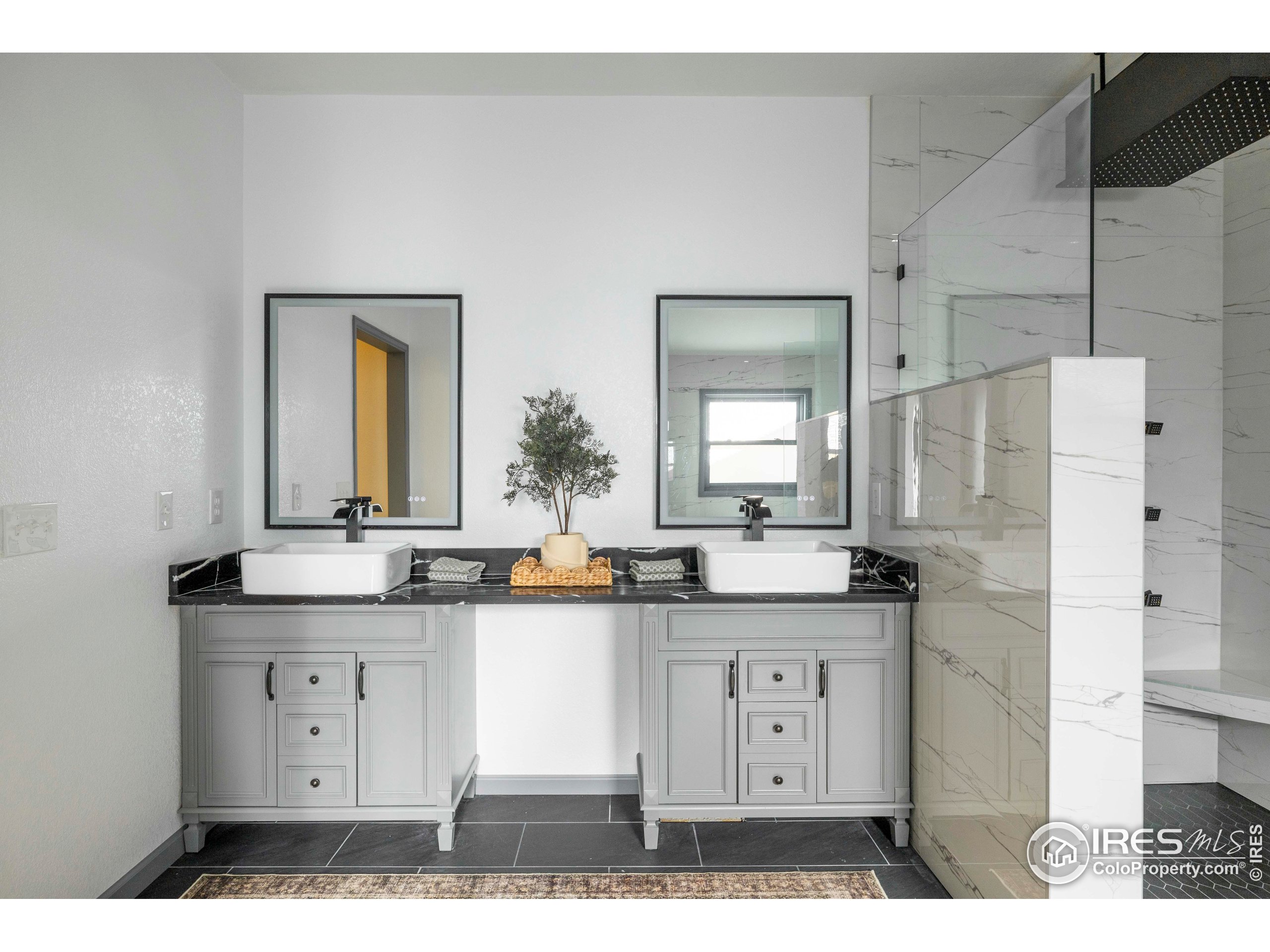 6465 Hidden Springs Road Fort Collins, CO 80526 - Photo 27 of 50 a large bathroom with a granite countertop sink and a mirror