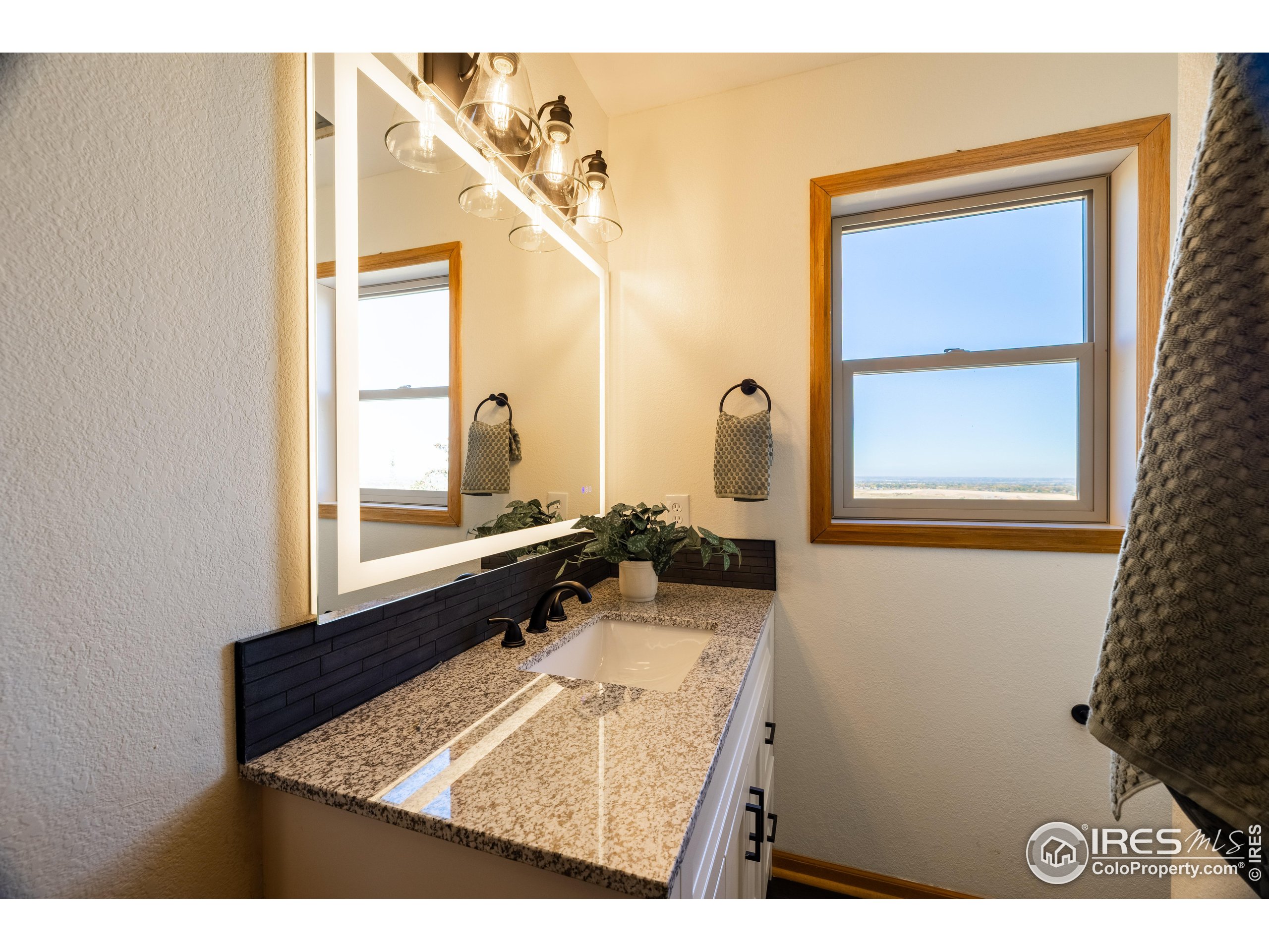 6465 Hidden Springs Road Fort Collins, CO 80526 - Photo 35 of 50 a bathroom with a sink mirror and a bathtub