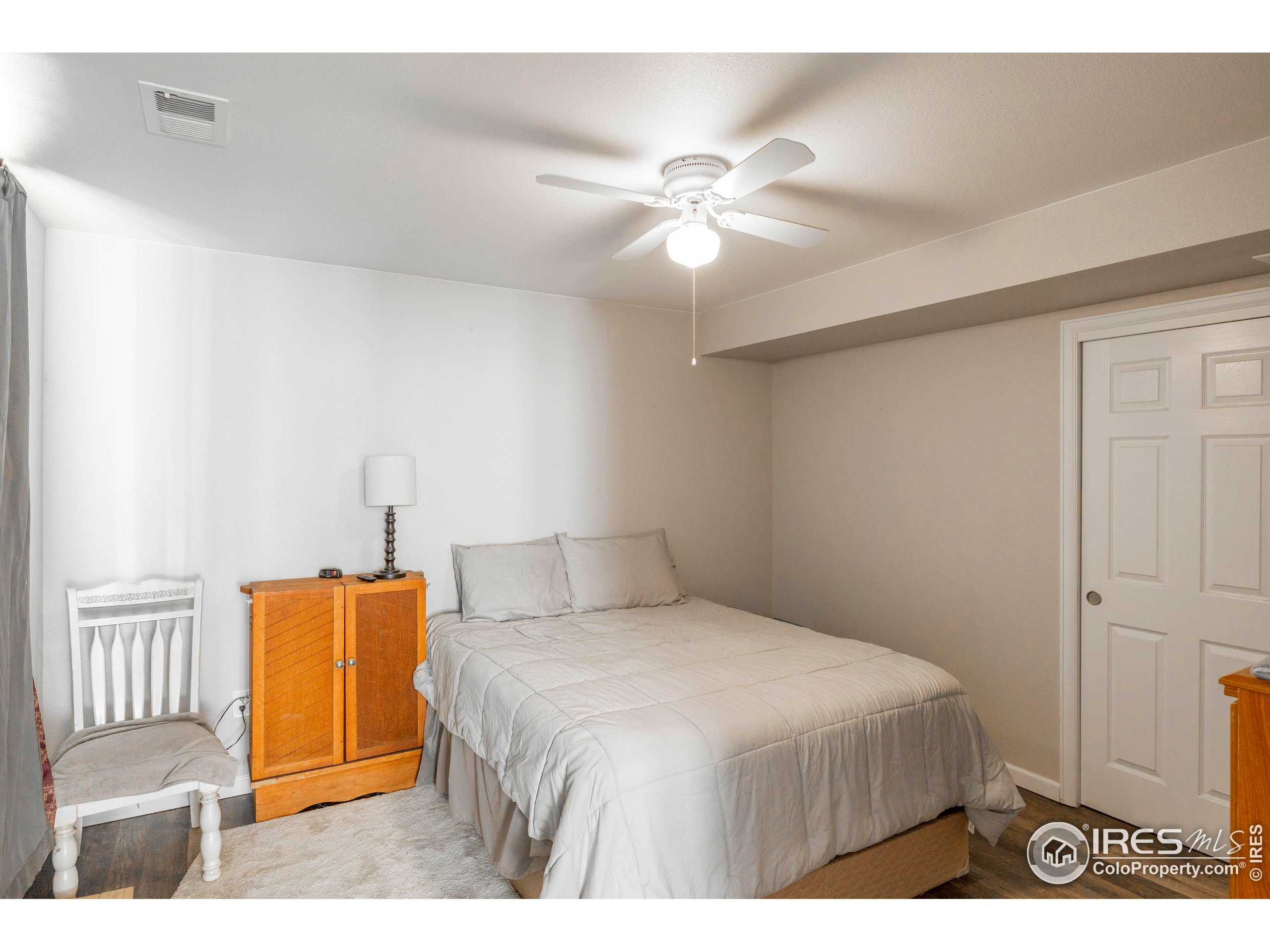 6465 Hidden Springs Road Fort Collins, CO 80526 - Photo 45 of 50 a bedroom with a bed and a chandelier