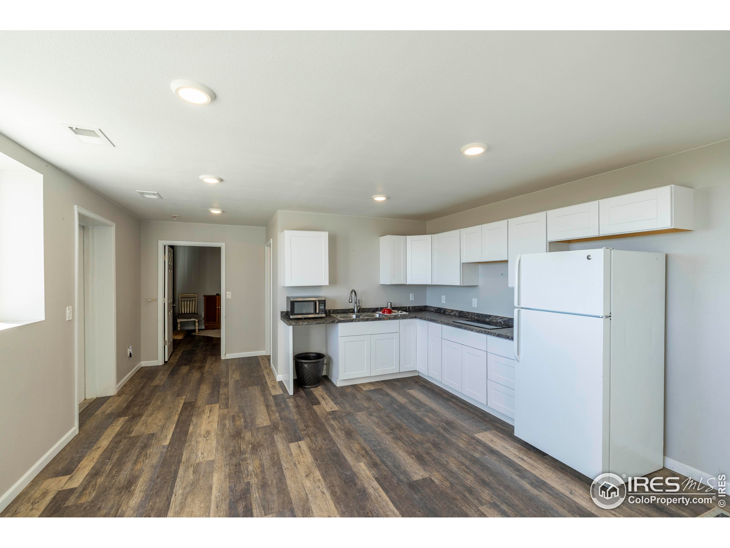 6465 Hidden Springs Road Fort Collins, CO 80526 - Photo 46 of 50 a kitchen with a refrigerator and a stove top oven