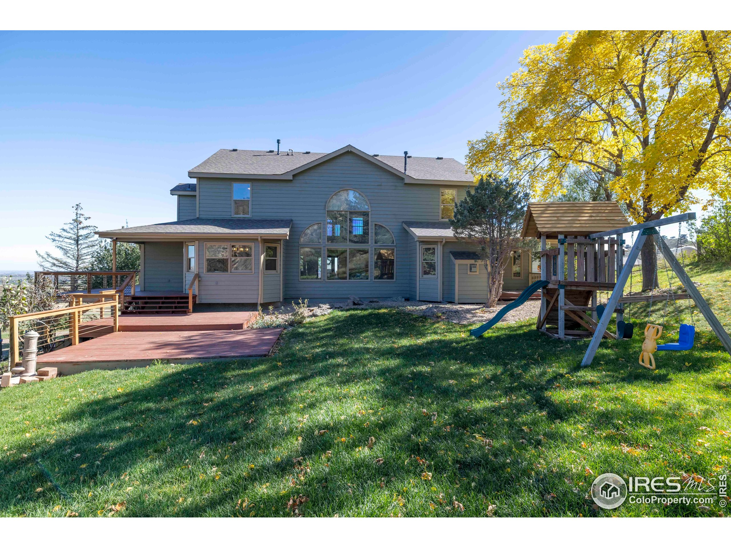 6465 Hidden Springs Road Fort Collins, CO 80526 - Photo 49 of 50 a view of a house with a yard and sitting area
