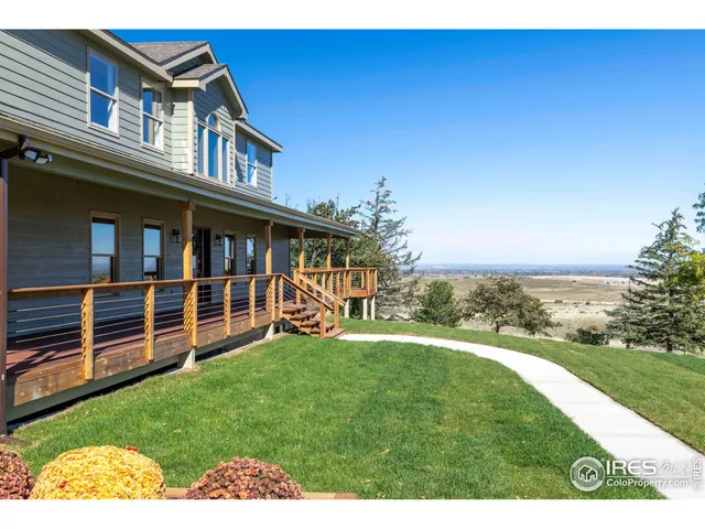 a view of a house with a yard and deck