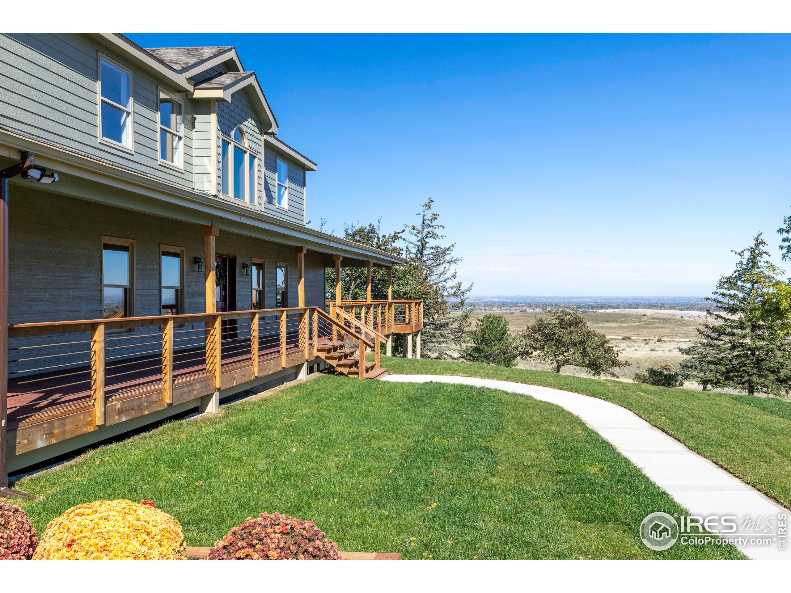 6465 Hidden Springs Road Fort Collins, CO 80526 - Photo 5 of 50 a view of a house with a yard and deck
