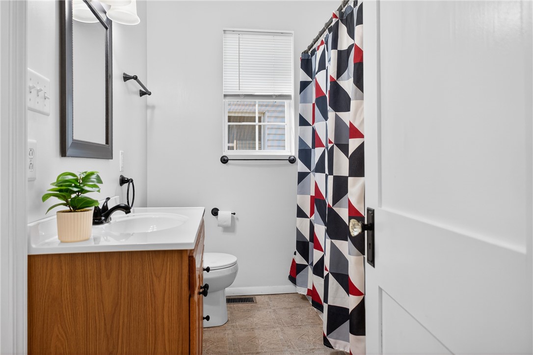 107 Riverside Drive Piqua, OH 45356 - Photo 19 of 69 This bathroom offers essential fixtures and a window for natural light.