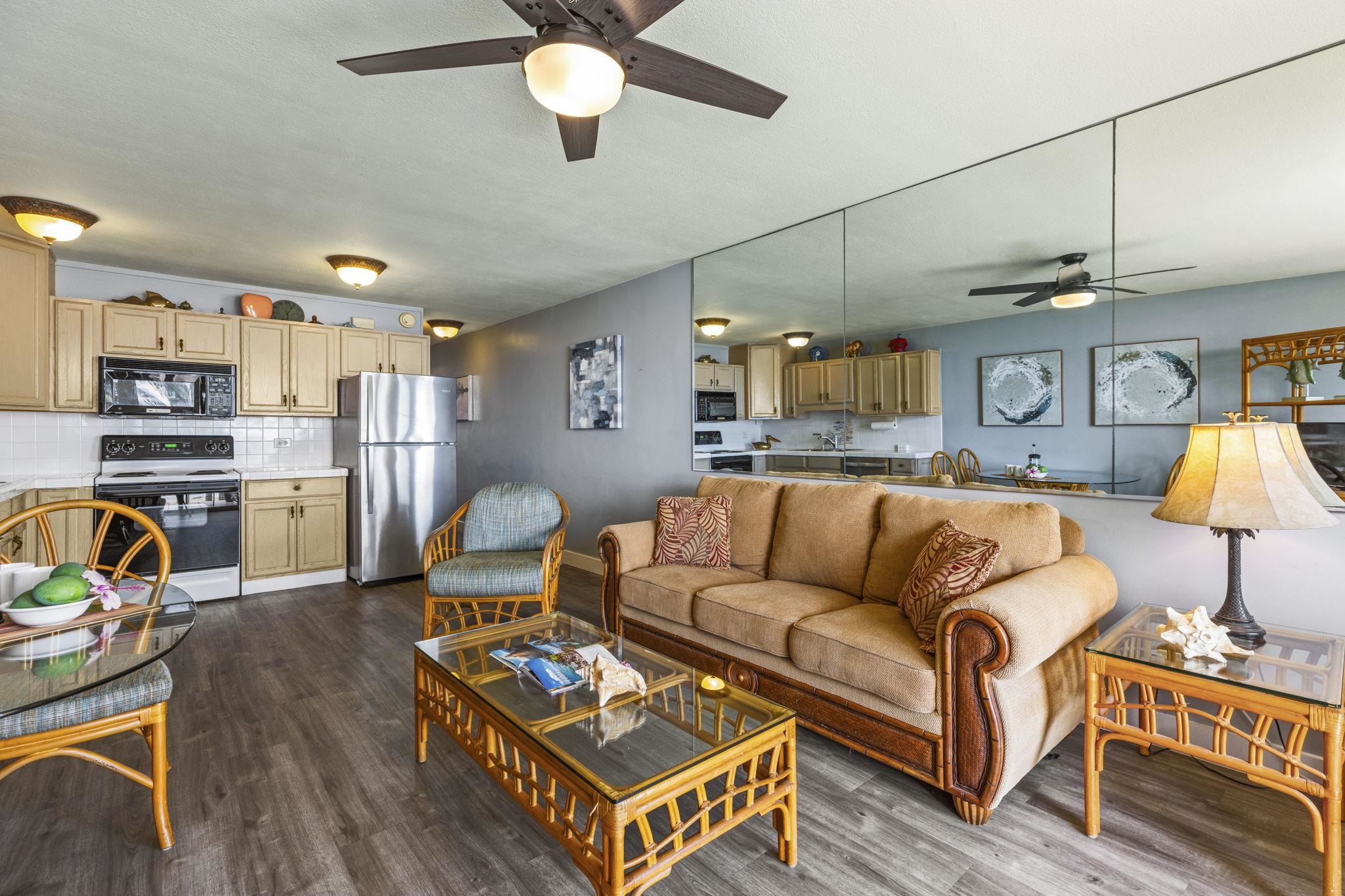 1310 Uluniu Road, Unit 317 Kihei, HI 96753 - Photo 19 of 50 a living room with furniture kitchen view and a wooden floor