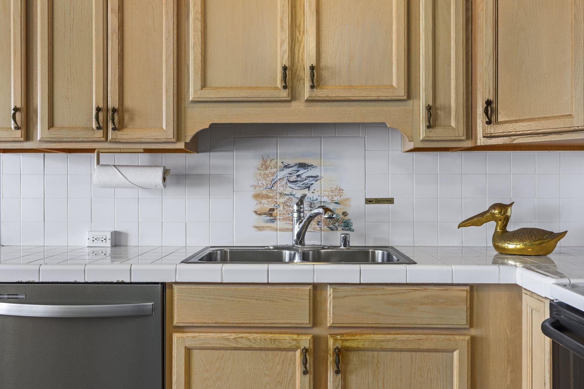 1310 Uluniu Road, Unit 317 Kihei, HI 96753 - Photo 22 of 50 a kitchen with a sink and cabinets