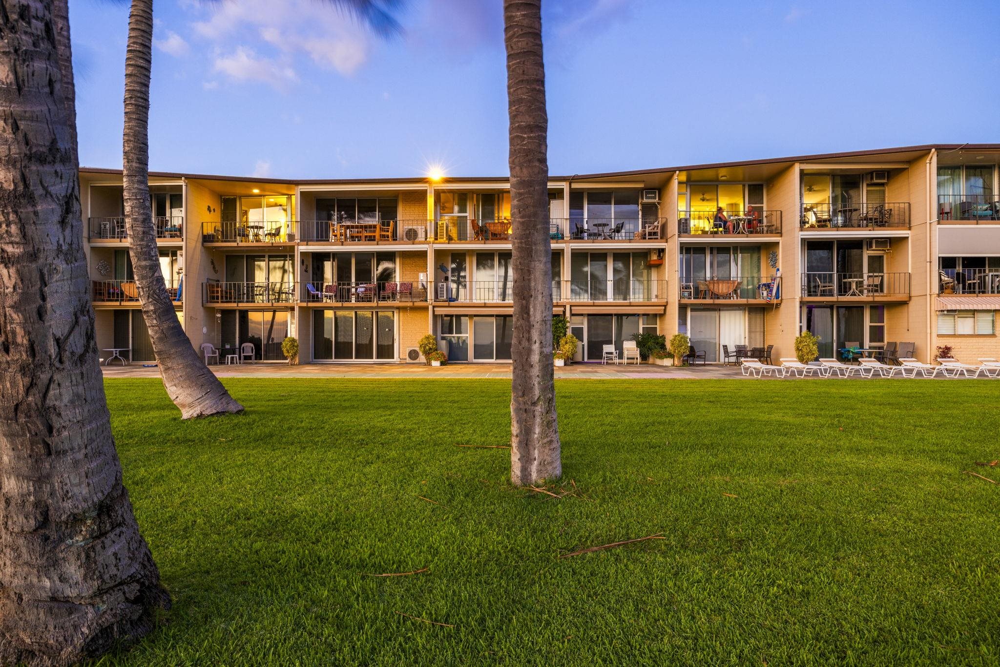 1310 Uluniu Road, Unit 317 Kihei, HI 96753 - Photo 47 of 50 a backyard of a building with glass windows and table