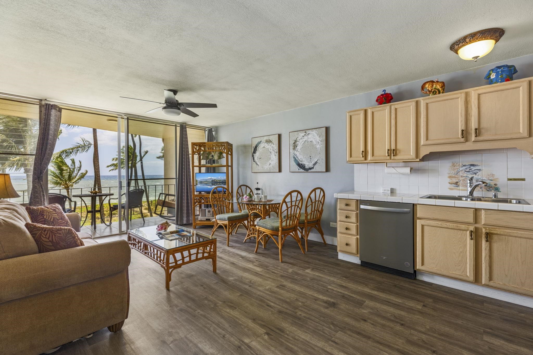 1310 Uluniu Road, Unit 317 Kihei, HI 96753 - Photo 6 of 50 a living room with furniture a rug a fireplace and a flat screen tv