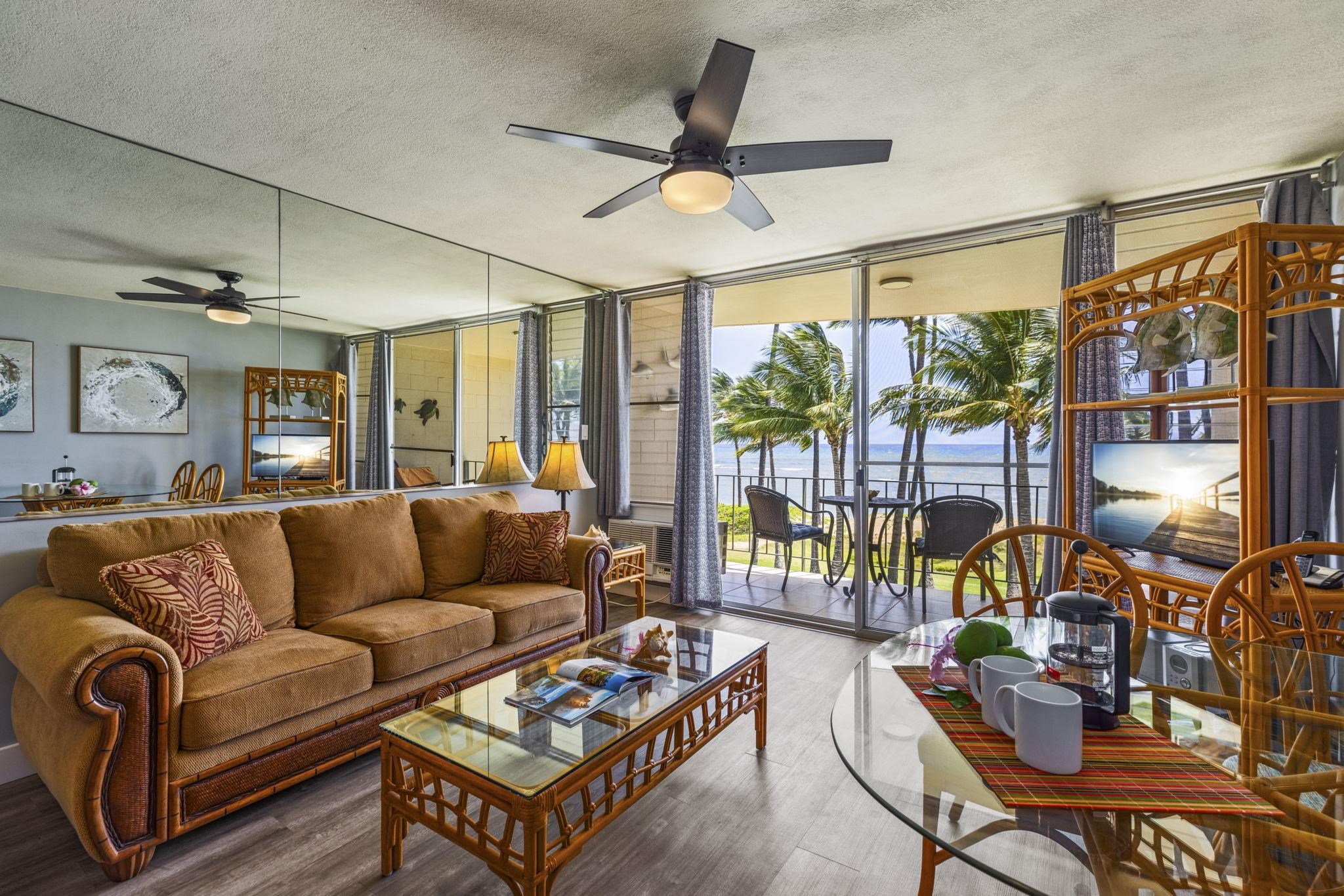 1310 Uluniu Road, Unit 317 Kihei, HI 96753 - Photo 7 of 50 a living room with furniture a ceiling fan and a rug
