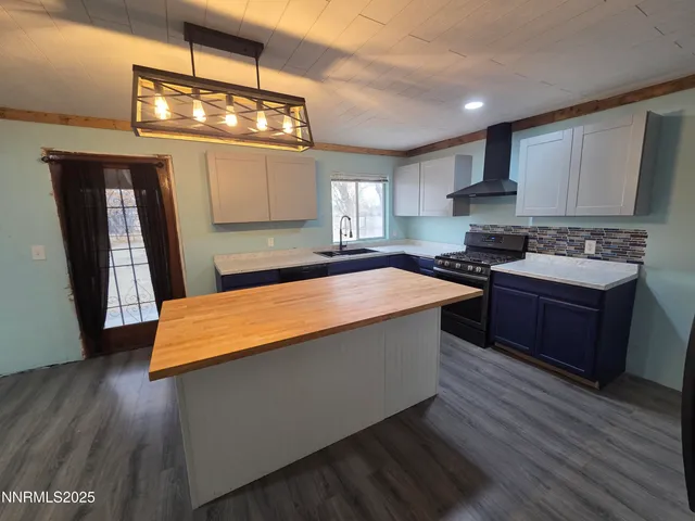 a kitchen with stainless steel appliances granite countertop wooden cabinets a stove a sink and a refrigerator