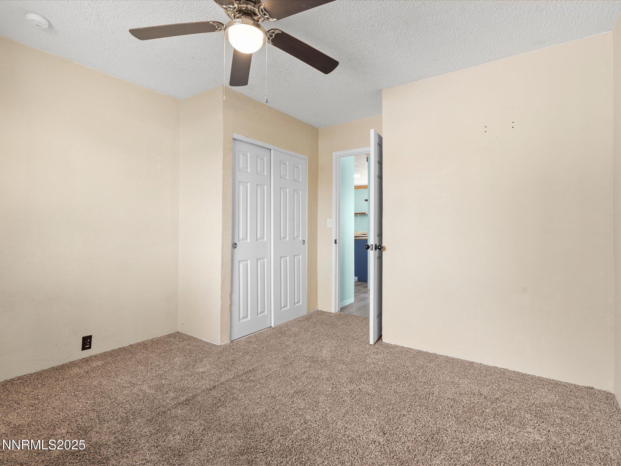 845 Mc Lean Street Fallon, NV 89406 - Photo 22 of 23 an empty room with a ceiling fan and a window