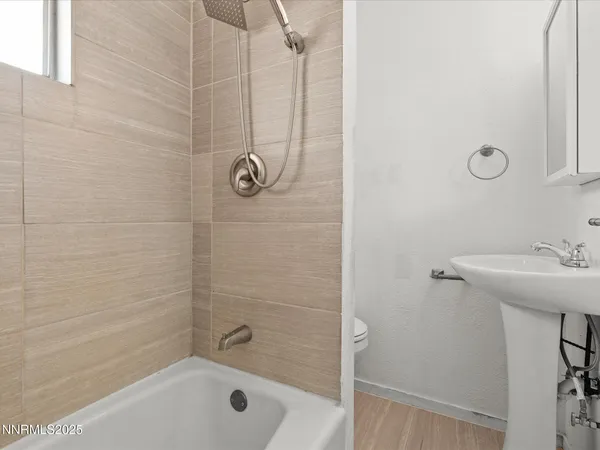 a bathroom with a shower a sink and a mirror