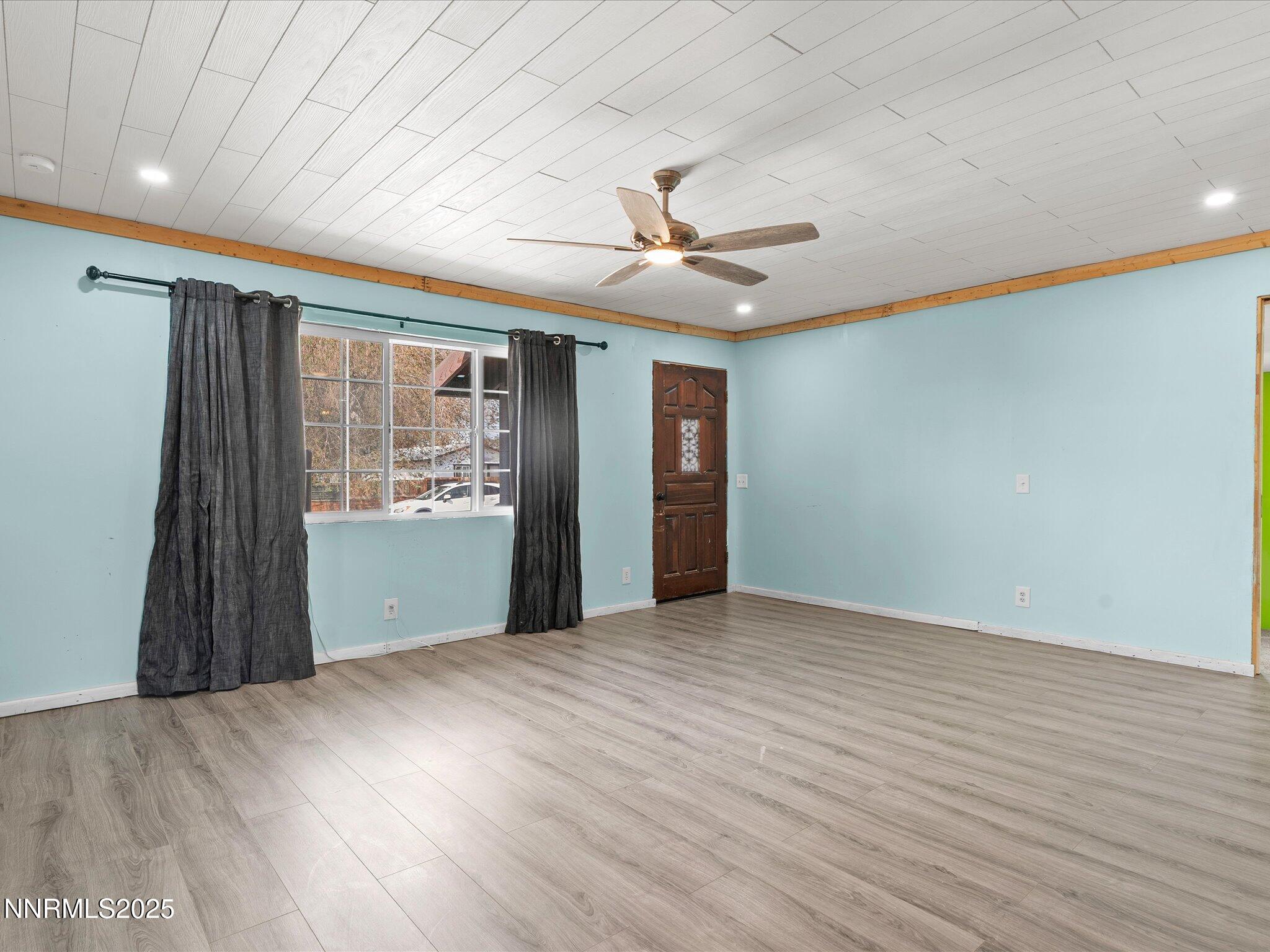 845 Mc Lean Street Fallon, NV 89406 - Photo 4 of 23 wooden floor in an empty room with a window